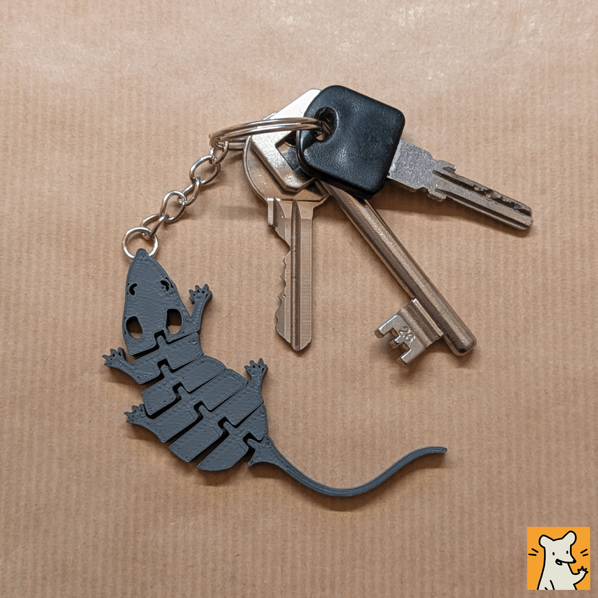 Articulated rat keychain charm on a keyring, perfect for small pet lovers and fidget toy enthusiasts.